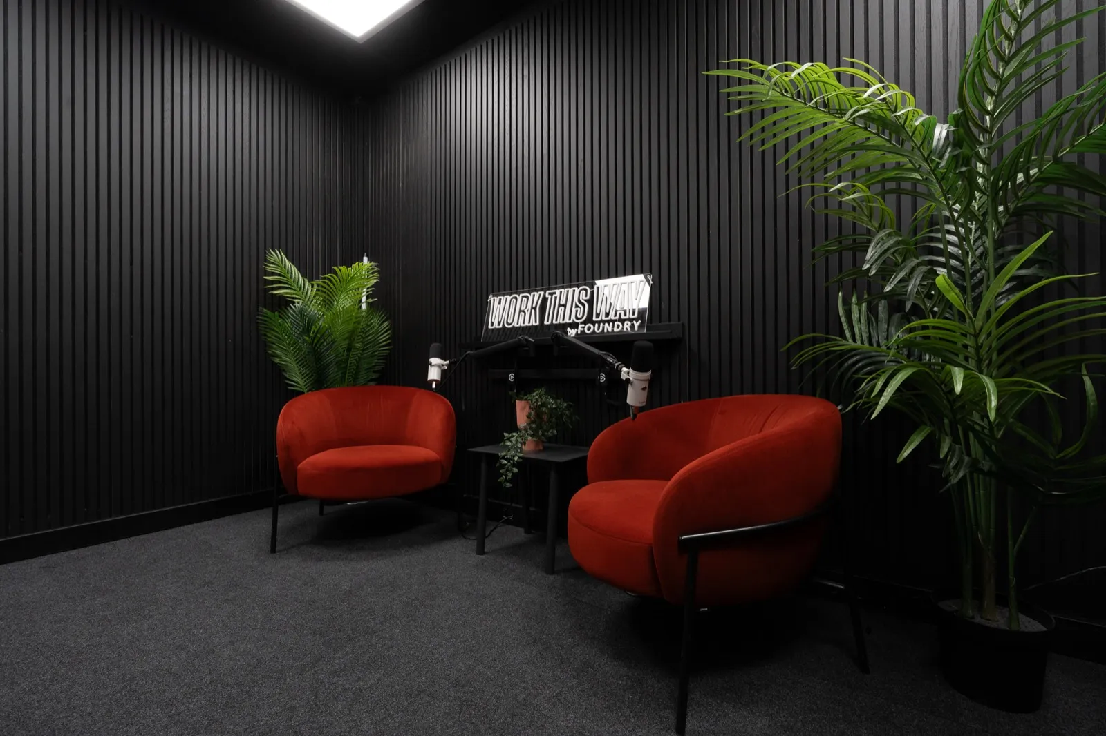 The little one set for an interview: two armchairs facing, a boom microphone at each